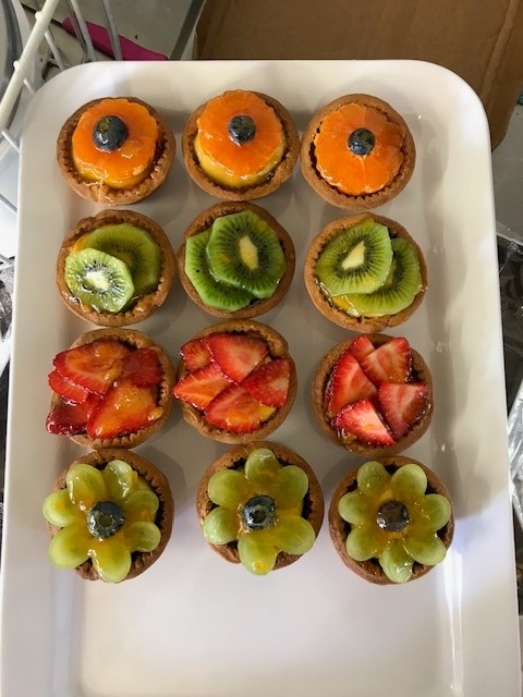 Fresh fruit tartlets topped with kiwi, strawberry and mandarin